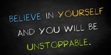 Motivational quote on a chalkboard: Believe in yourself and you will be unstoppable.