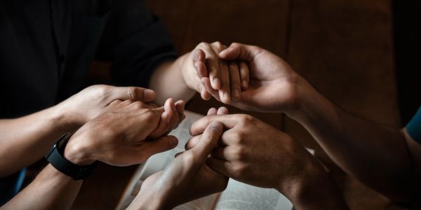 People holding hands in unity and support.