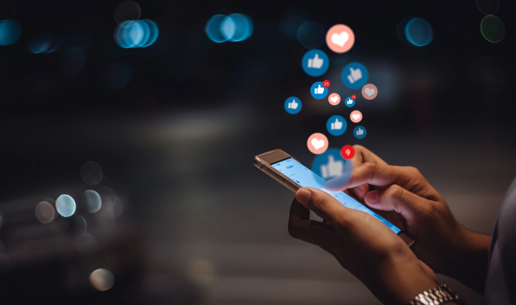 Person engaged with mobile device, clicking lots of icons, including thumb's up and hearts.
