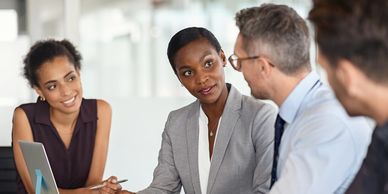 Four colleagues have a meeting, discussing business.