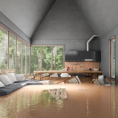 Flooded modern living room with muddy water covering the floor.