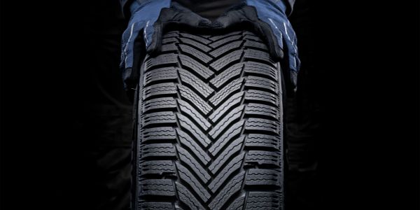 Close-up of hands holding a tire tread pattern.