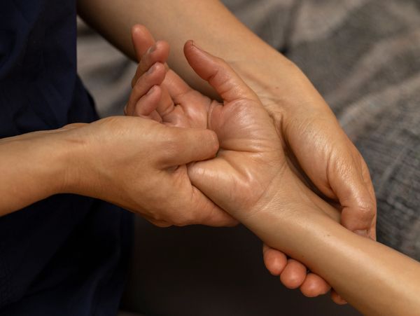 Therapist performing Reiki and Shiatsu energy balance therapy at Wholly Spirit Hands Sugar Land.