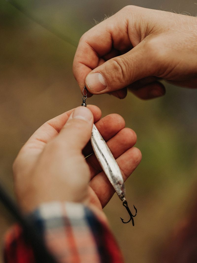 Man out in nature by a lake fishing with rodPhoto taken outdoors by a put and take lake