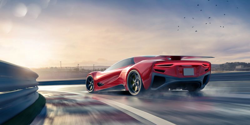 A generic electric sports car moving at high speed around a corner of a slightly wet racetrack in rear view with brake lights on. Under a clear dusk/dawn sky with lots of motion blur to track foreground and wheels.