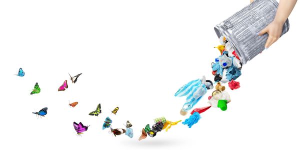 Trash transforming into colorful butterflies as it's poured from a bin.