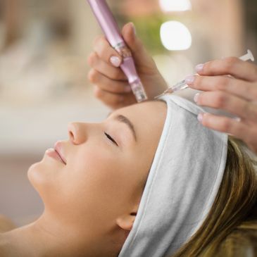 Woman receiving a facial injection treatment at a spa.