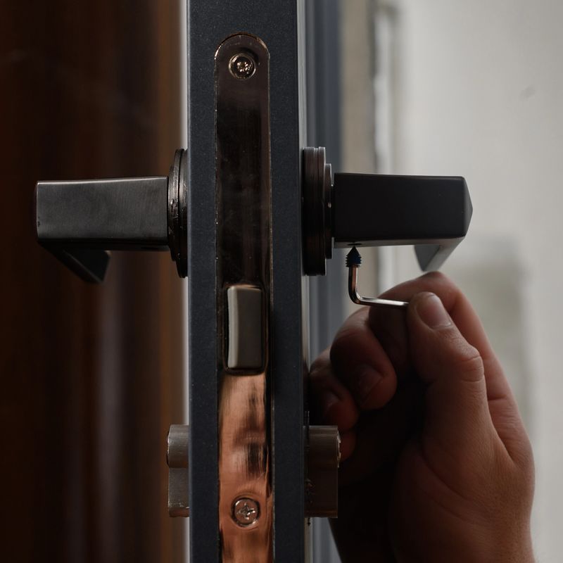 The craftsman installs the door handle with the help of a sprocket key, installation work with doors, installation close-up.