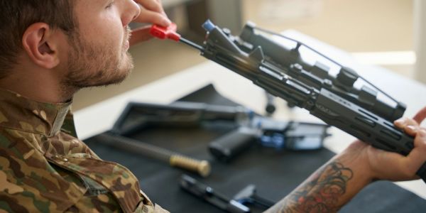 Man cleaning a rifle.