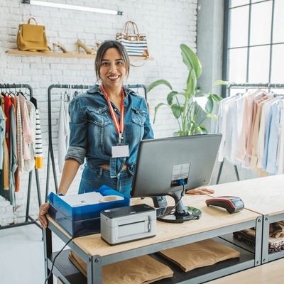 Smiling saleswoman in a clothing store at the checkout.