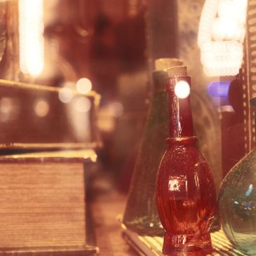 Vintage glass bottles and old books on display.