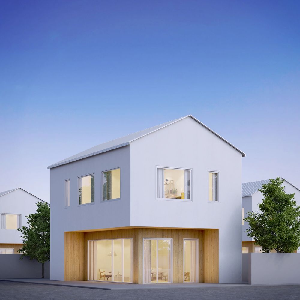 Modern two-story house with white and wood exterior under clear blue sky.