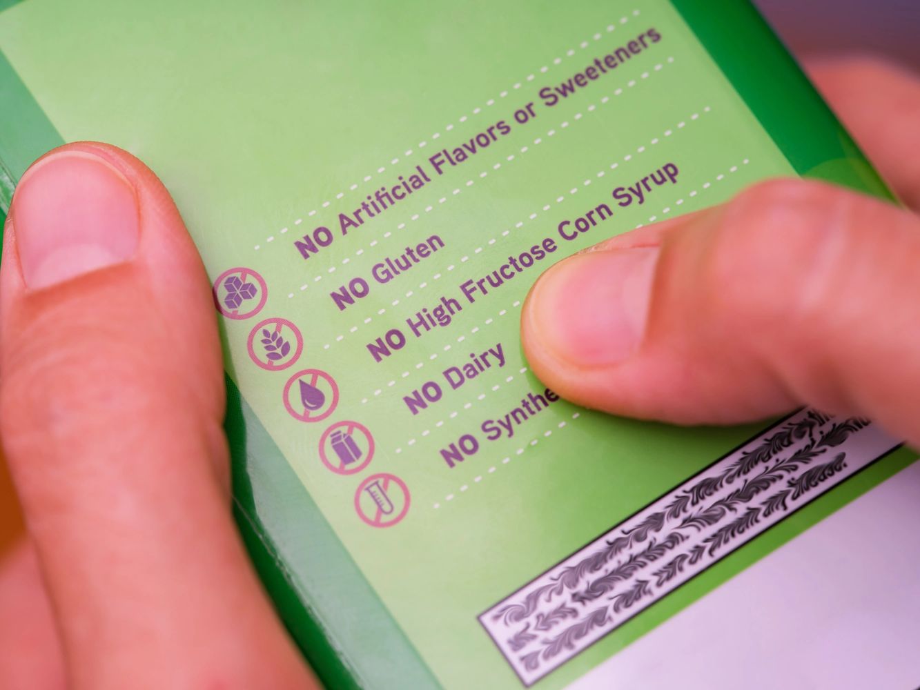 Close-up of product label listing various 'No' ingredients and allergens.