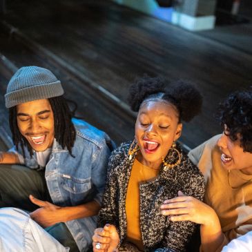 Three friends laughing and enjoying each other's company.