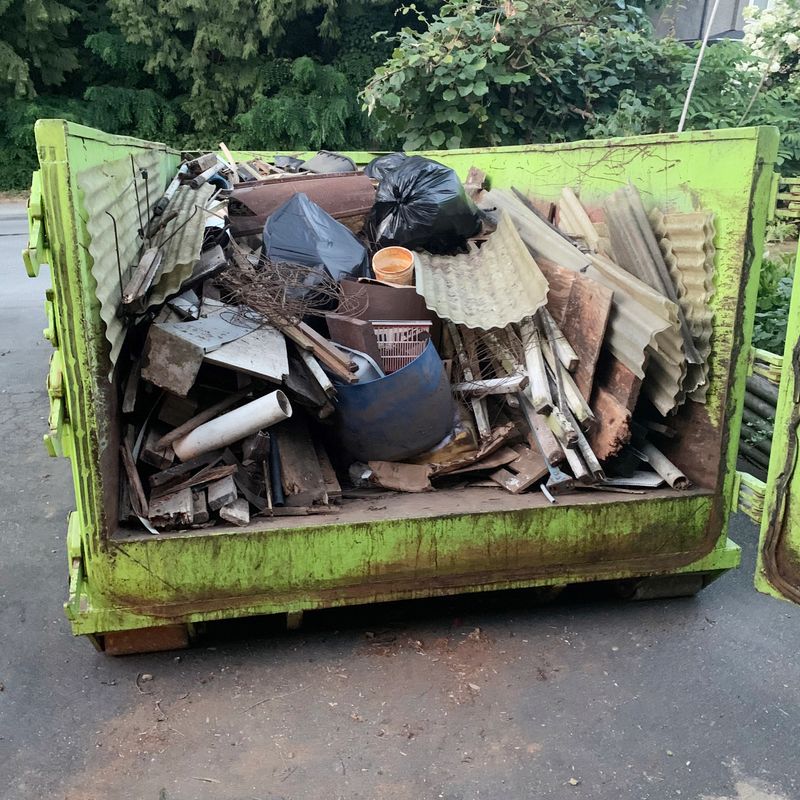 Closeup of a 25 yard dumpster with a load full of garbage.