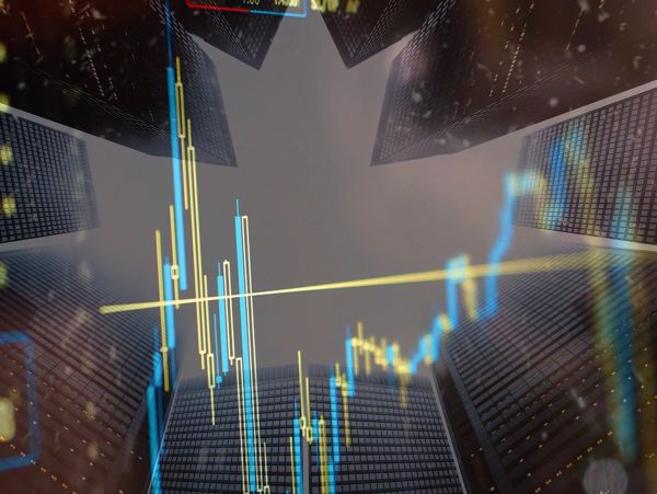 Stock market graph overlay on skyscraper buildings.