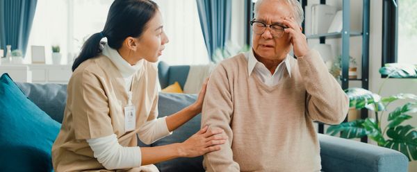 Compassionate caregiver assisting an elderly person