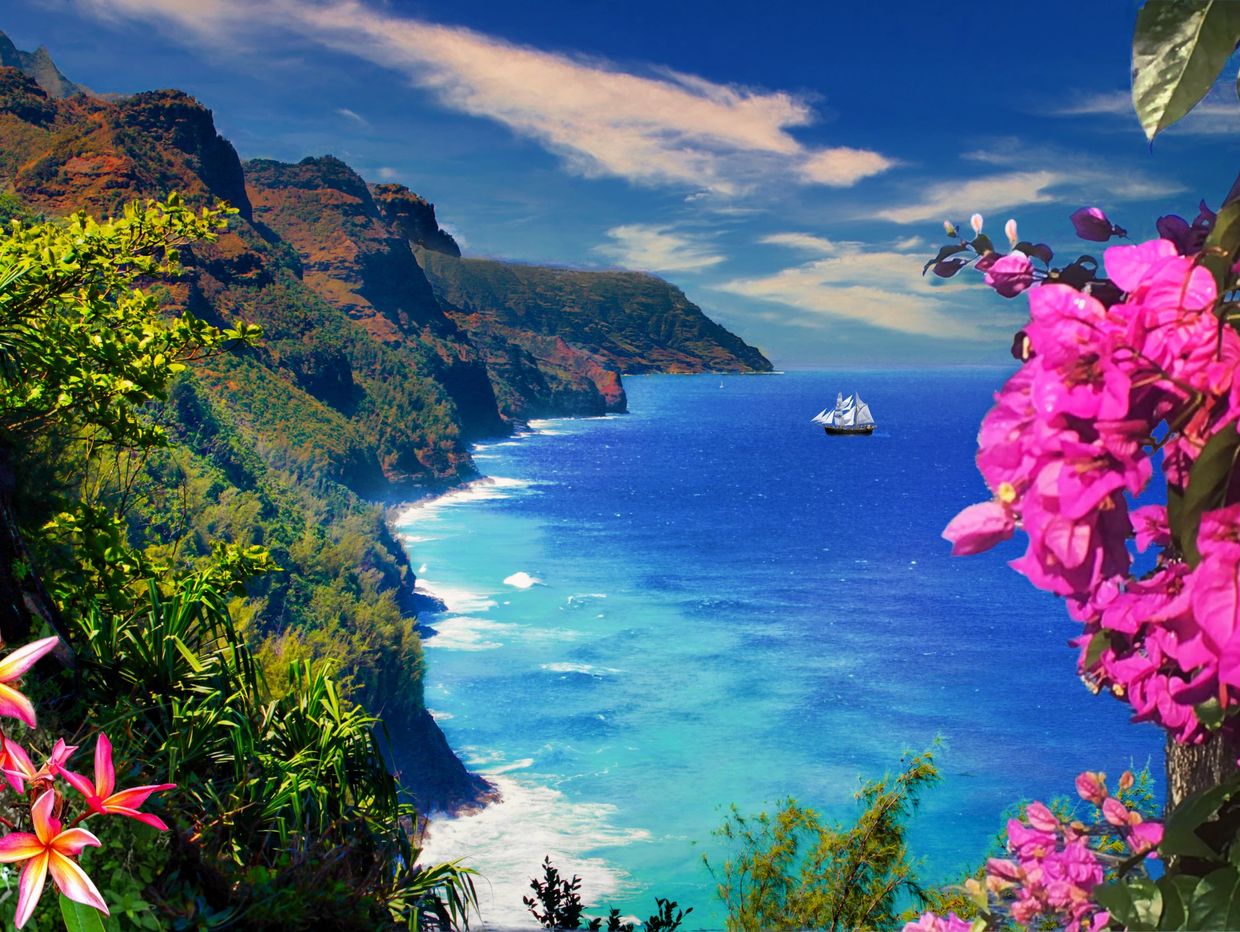 Tropical coastline with vibrant flowers and a sailboat.