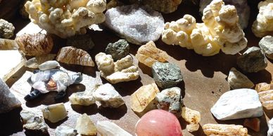 A collection of various rocks and minerals displayed on a surface.