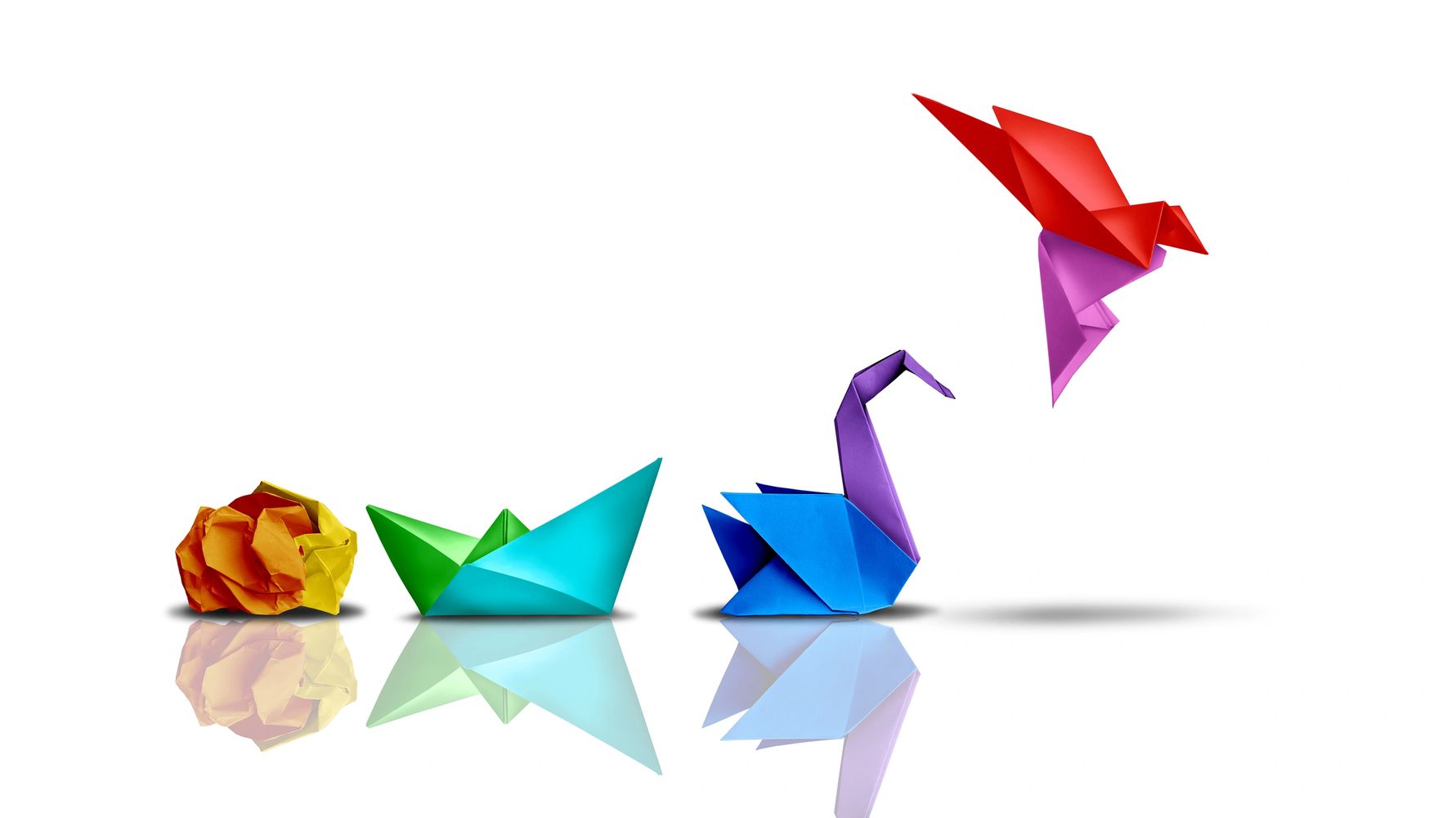 Colorful crumpled papers forming a head with a red origami bird flying out.
