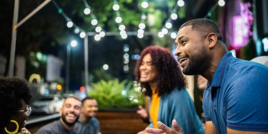 Friends enjoying a lively outdoor night gathering.