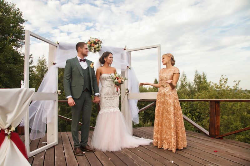 Registrar having official wedding ceremony next to Bridal couple. Bride and groom on wed irish style event in country outdoors. Marriage registration office and happiness married. Copy text space