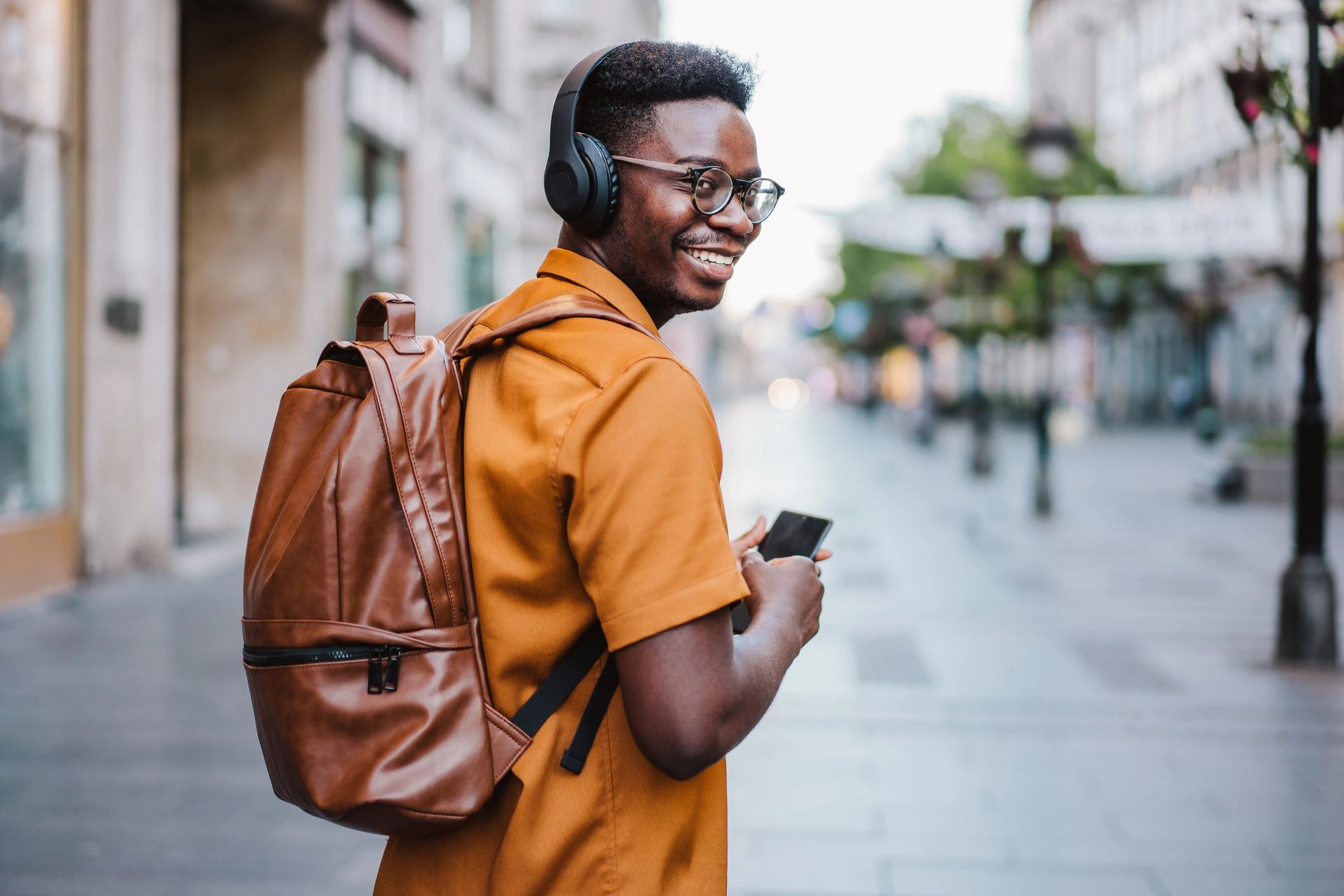 Man with brown leather backpack.
