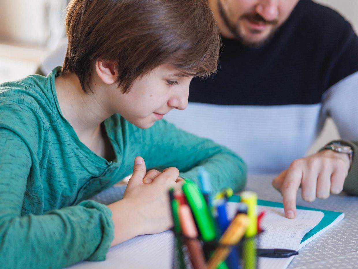 Adult helping a child with homework.
