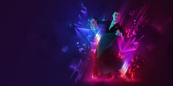 A ballroom dance couple performing amidst vibrant neon lights.
