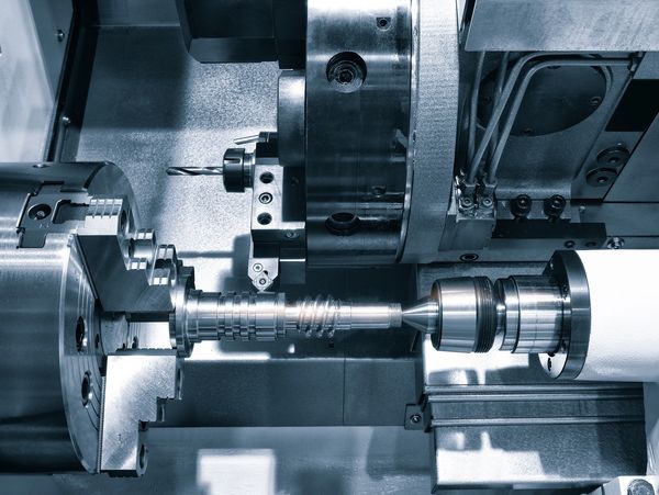 Close-up of a CNC lathe machining a metal part.