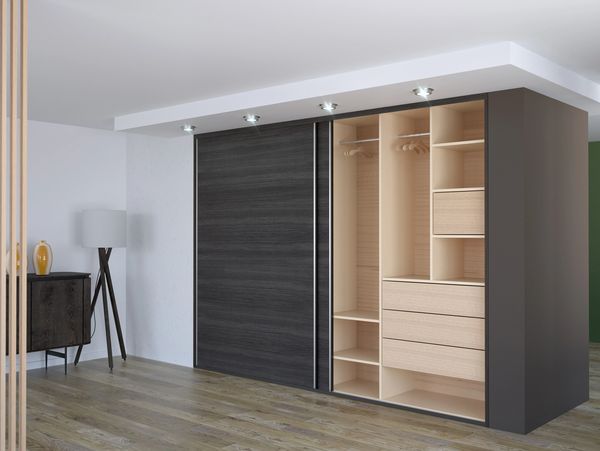 Modern wardrobe with sliding doors and built-in lighting in a minimalist room.