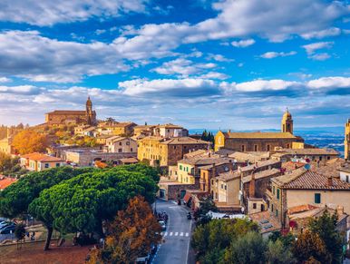 Scenic view of a historic town with stone buildings under a blue sky.