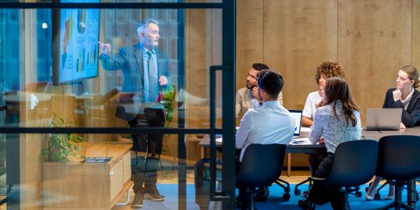 Business meeting with presentation and attentive team.