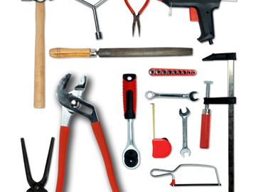 A collection of various hand tools arranged on a white surface.