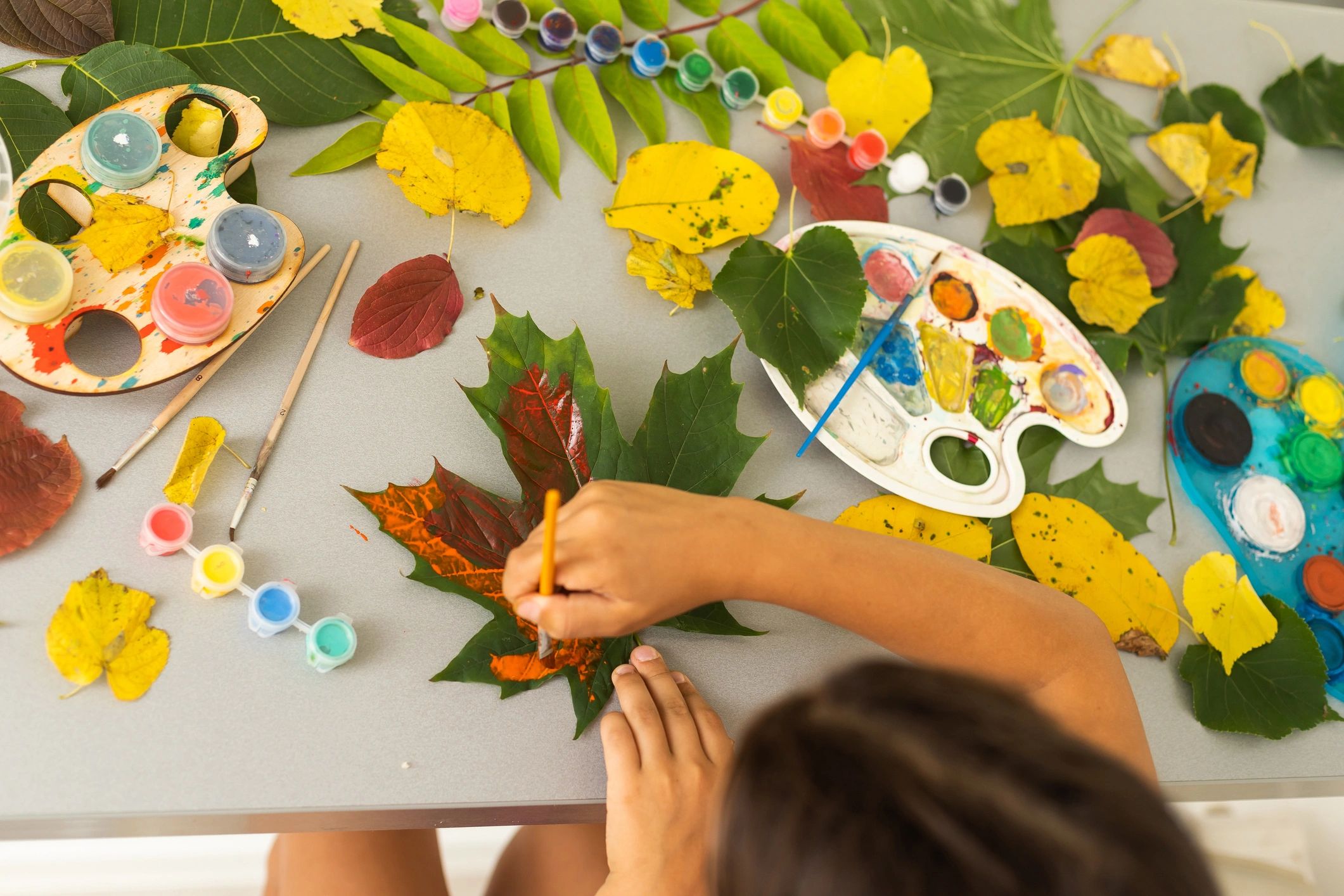 child painting leaves