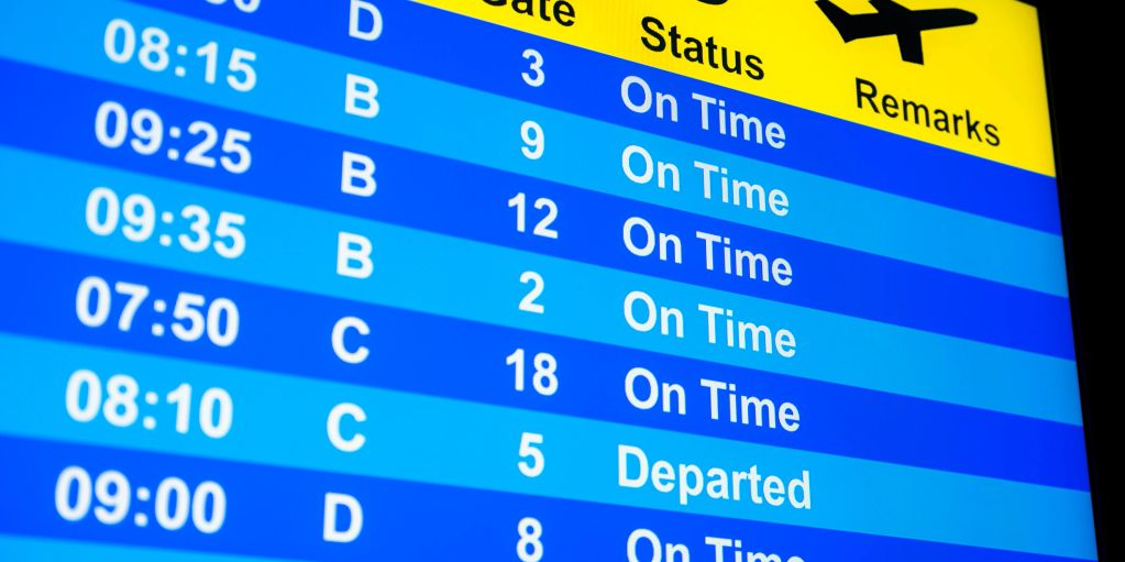 Airport flight departure board showing on-time and departed flights.