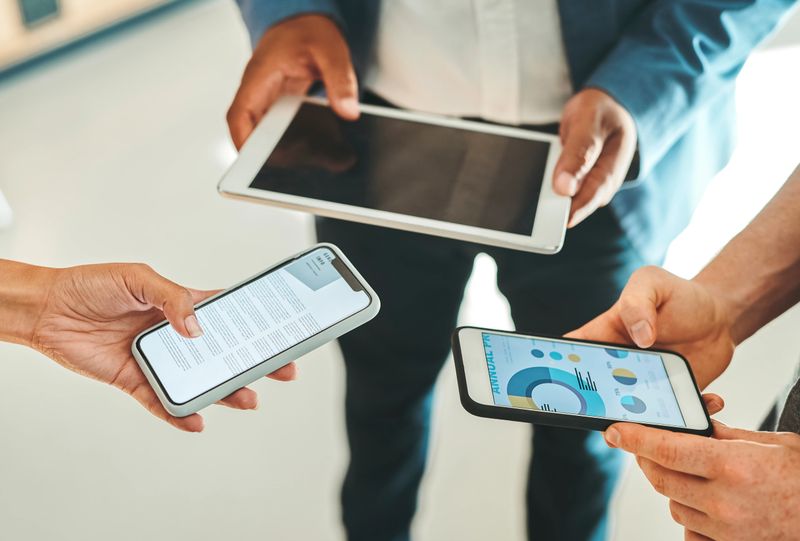 Business people hands on smartphone and digital tablet closeup, ERP finance budget report ppt graph presentation chart. UX software, website marketing industry company team use mobile technology app.