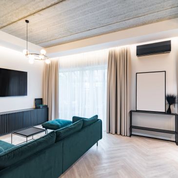 Modern living room with green sofa and minimalist decor.