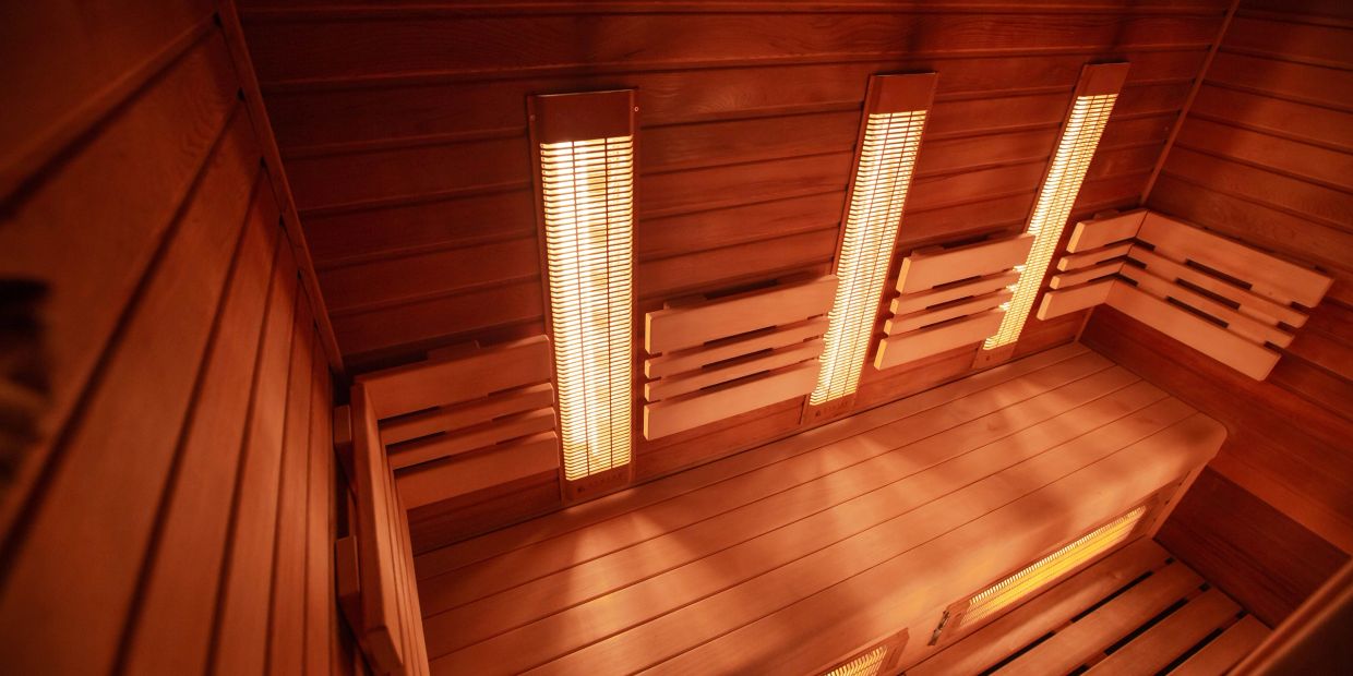 Interior view of a wooden sauna with heating panels.