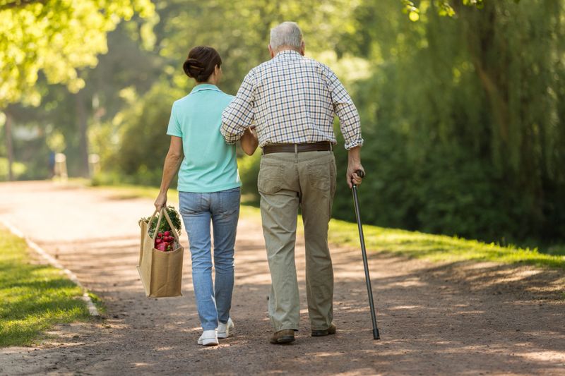 Caregiver – woman helping senior man with shopping