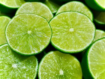 Limones verdes cortados por la mitad.