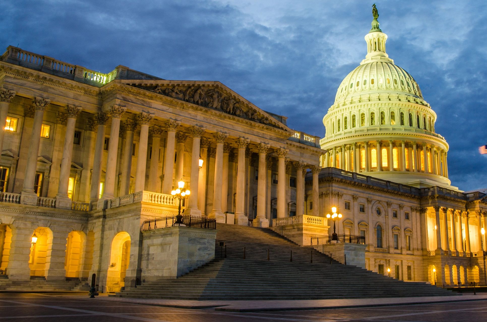 The U.S. Capitol building lit up at dusk.