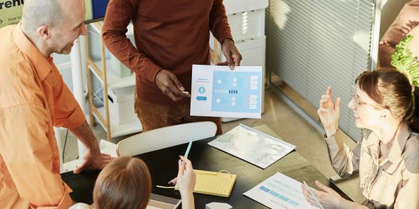 Team discussing a chart during a meeting.