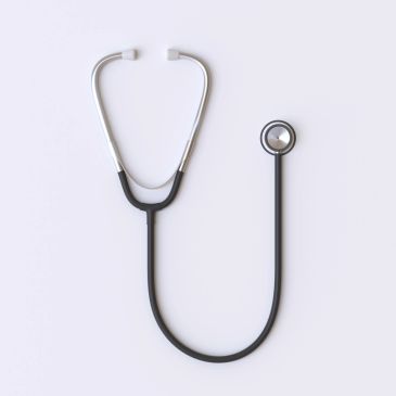 A black and silver stethoscope on a white background.