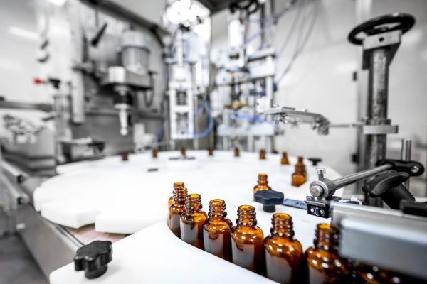 Amber glass bottles in an automated filling line.