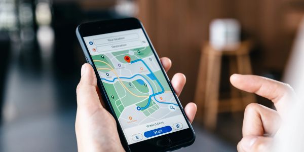 Person using smartphone for navigation with map app.