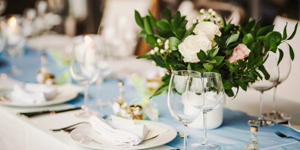 Elegant table setting with floral centerpiece and glassware for a special occasion.