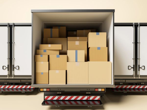 Open delivery truck filled with various cardboard boxes ready for shipment.