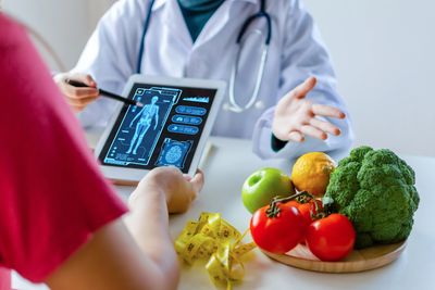 Doctor consulting patient using digital health data.