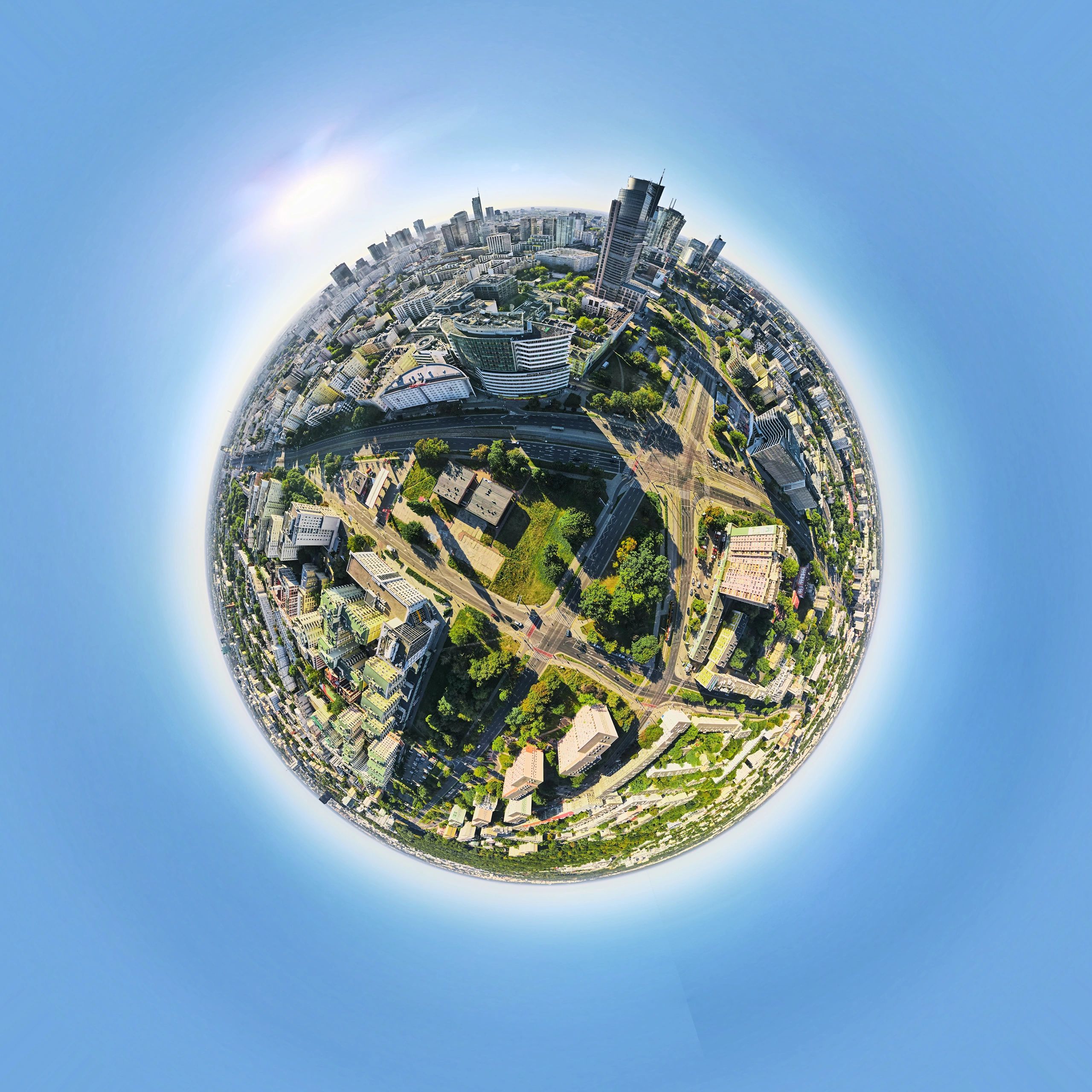 Panoramic fisheye view of a city skyline with tall buildings and clear sky.